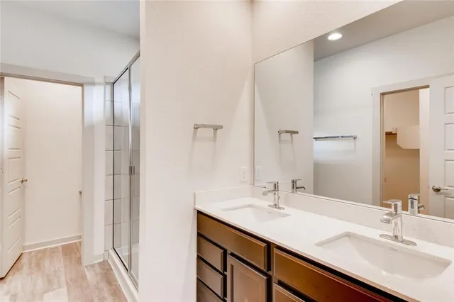 a bathroom with a double vanity sink and a mirror