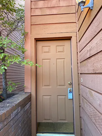 a view of a room with wooden floor and a window