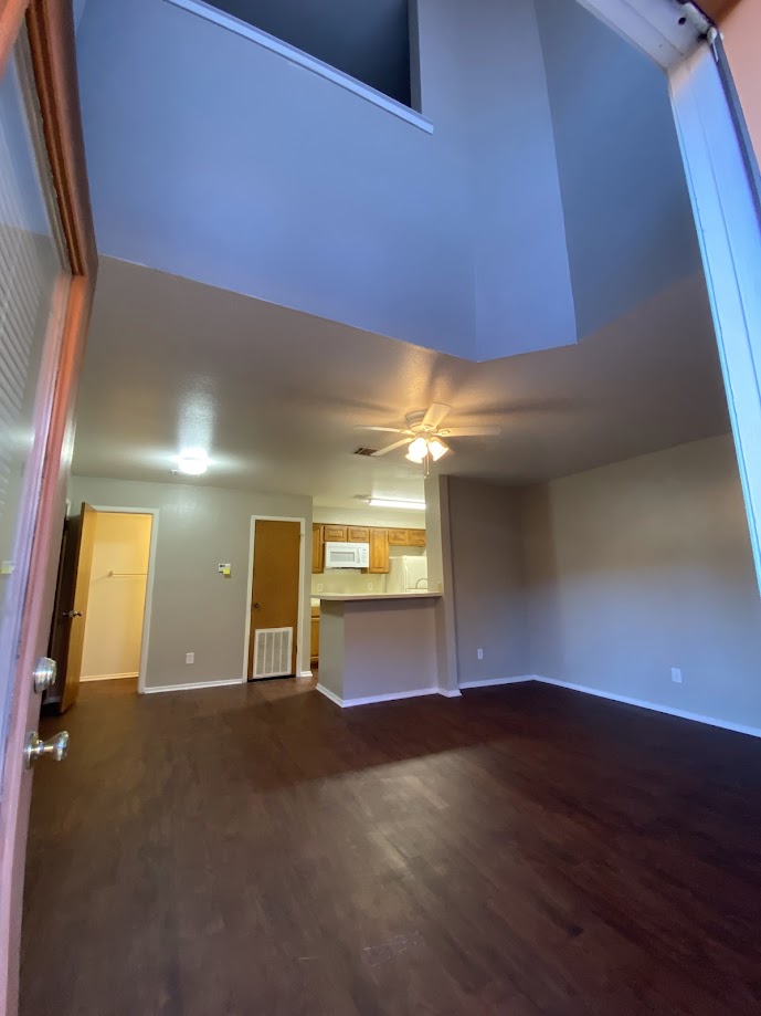 1305 West Villa Maria Road, Unit B107 Bryan, TX 77801 - Photo 3 of 17 a view of a room with wooden floor and a window