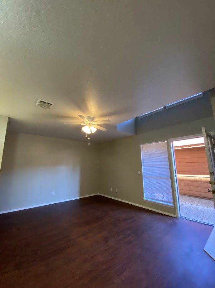 1305 West Villa Maria Road, Unit B107 Bryan, TX 77801 - Photo 6 of 17 an empty room with wooden floor and windows