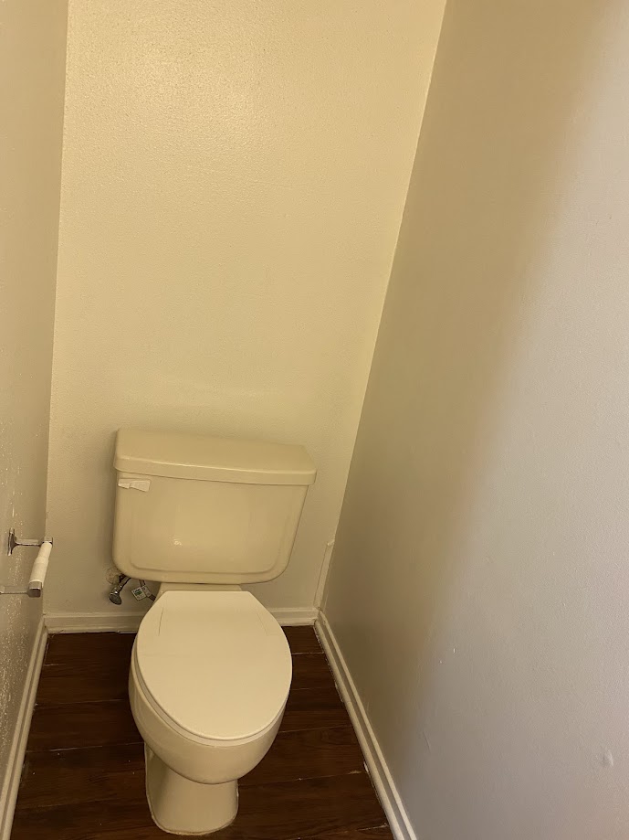 1305 West Villa Maria Road, Unit B107 Bryan, TX 77801 - Photo 8 of 17 a white toilet sitting next to a white wall