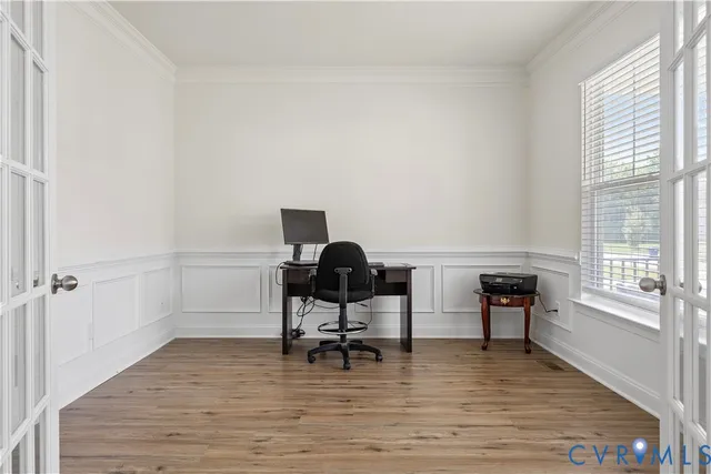 a view of a workspace with furniture and a window