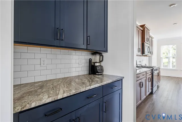 a kitchen with granite countertop cabinets and white appliances