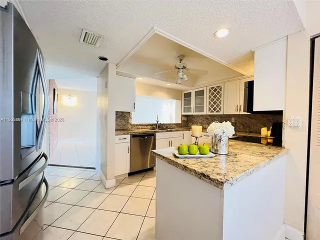 a kitchen with a sink appliances and cabinets