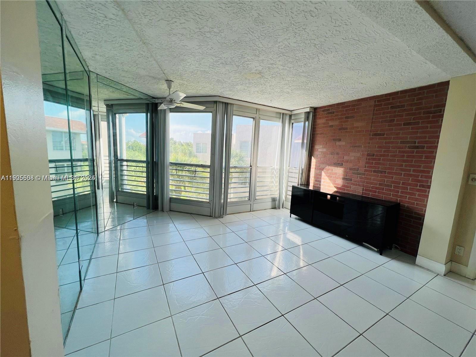 1830 Sabal Palm Drive, Unit 406 Davie, FL 33324 - Photo 6 of 16 a view of an empty room with a window