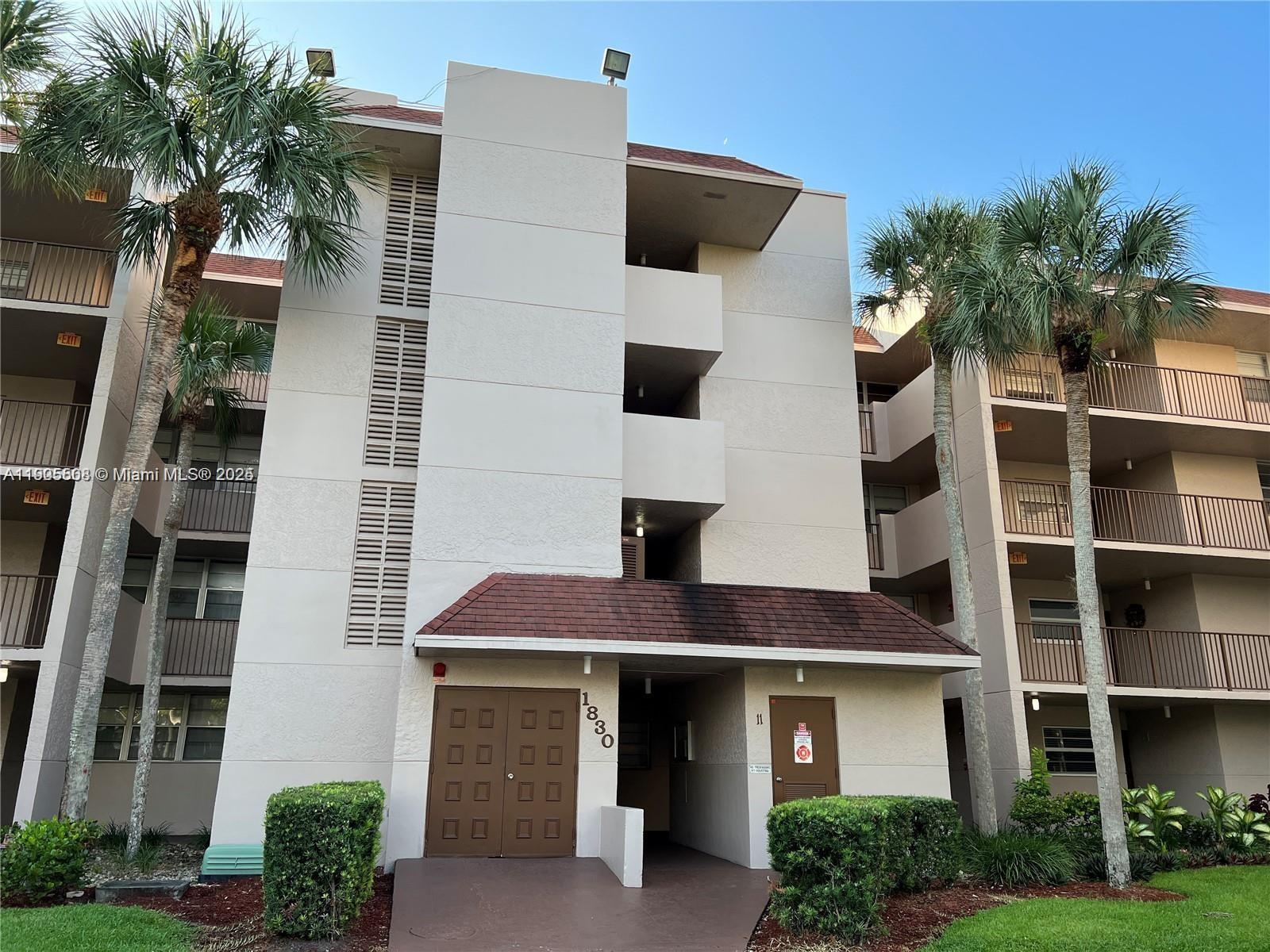 1830 Sabal Palm Drive, Unit 406 Davie, FL 33324 - Photo 10 of 16 a front view of a multi story building