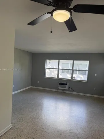 an empty room with a empty space and a window