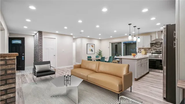a living room with furniture and kitchen view