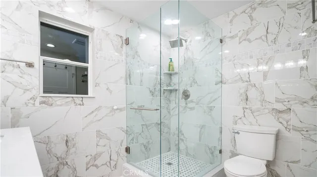 a bathroom with a toilet sink and shower