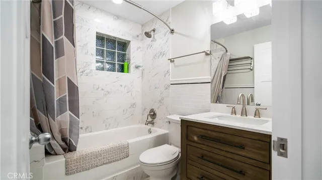 a bathroom with a sink a toilet and a bathtub
