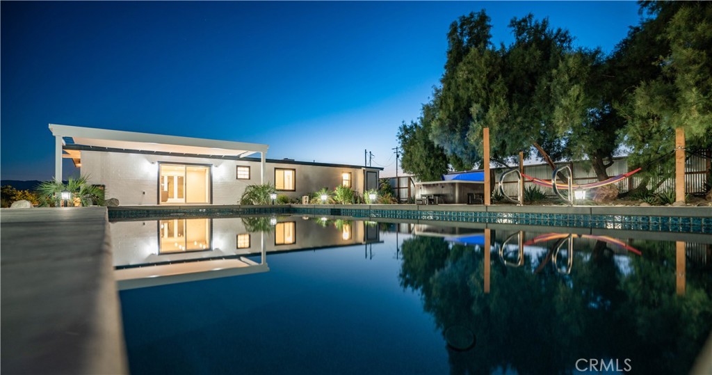 72160 Winters Road Twentynine Palms, CA 92277 - Photo 2 of 33 a view of swimming pool with seating area and lake view