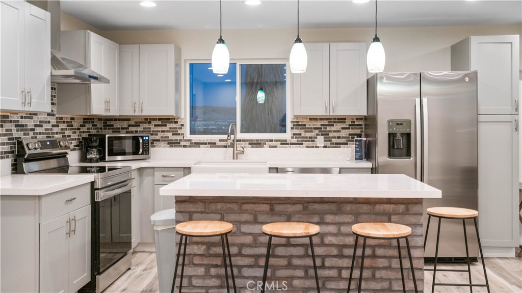 72160 Winters Road Twentynine Palms, CA 92277 - Photo 7 of 33 a kitchen with a table chairs sink and cabinets