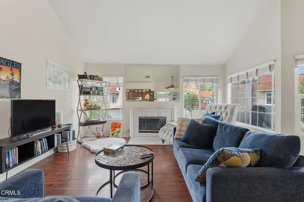 a living room with furniture flat screen tv and a fireplace