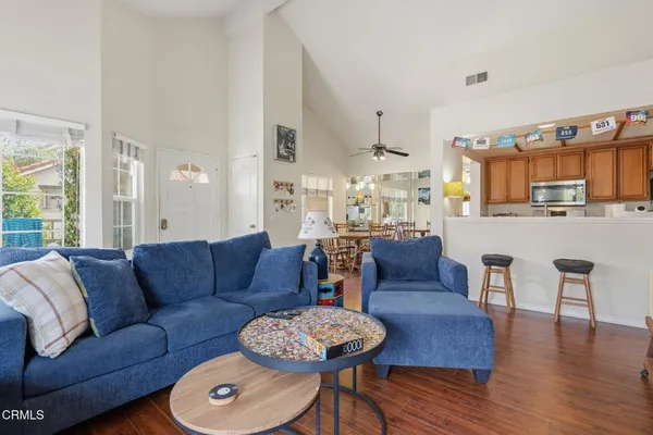 a living room with furniture and a wooden floor