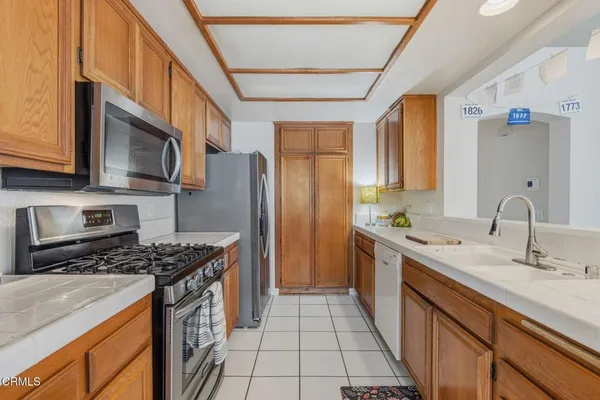 a kitchen with stainless steel appliances granite countertop a stove and a sink