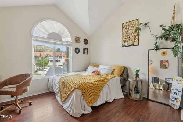a bedroom with a bed and a chair