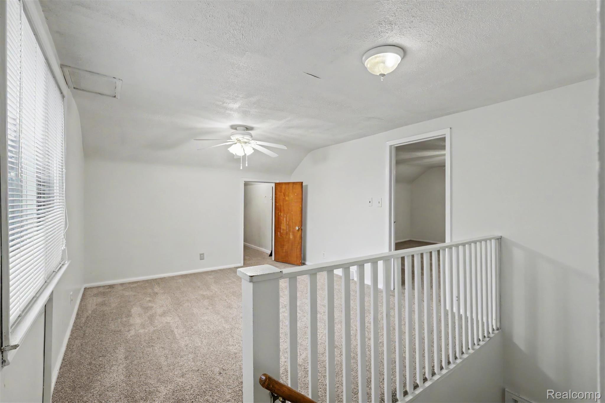 7136 Rosedale Boulevard Allen Park, MI 48101 - Photo 39 of 51 Carpeted room with a vaulted ceiling, ceiling fan, and white window blinds