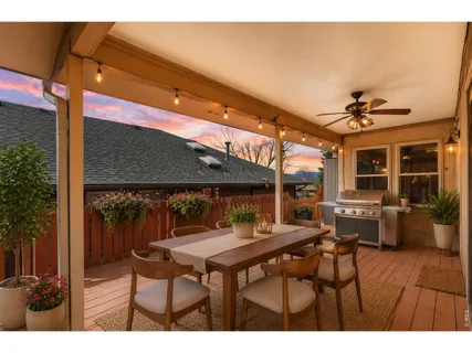 a backyard of a house with barbeque oven table and chairs