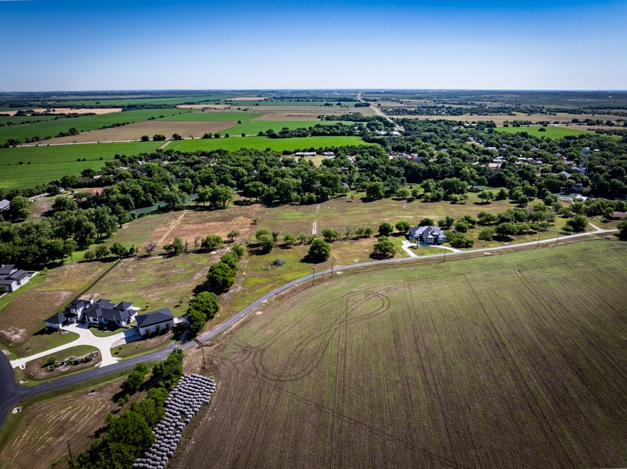 110 Rustic River Street Martindale, TX 78655 - Photo 17 of 28 Aerial view of property and surrounding area with rural landscape and large plots for crops