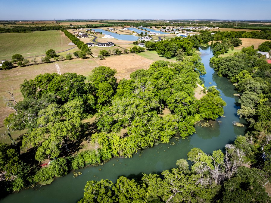 110 Rustic River Street Martindale, TX 78655 - Photo 7 of 28 Bird's eye view of a nearby body of water and a tree filled landscape