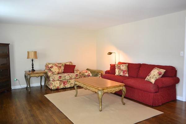 102 Jericho Road, Unit 102 Weston, MA 02493 - Photo 3 of 9 a living room with furniture and wooden floor