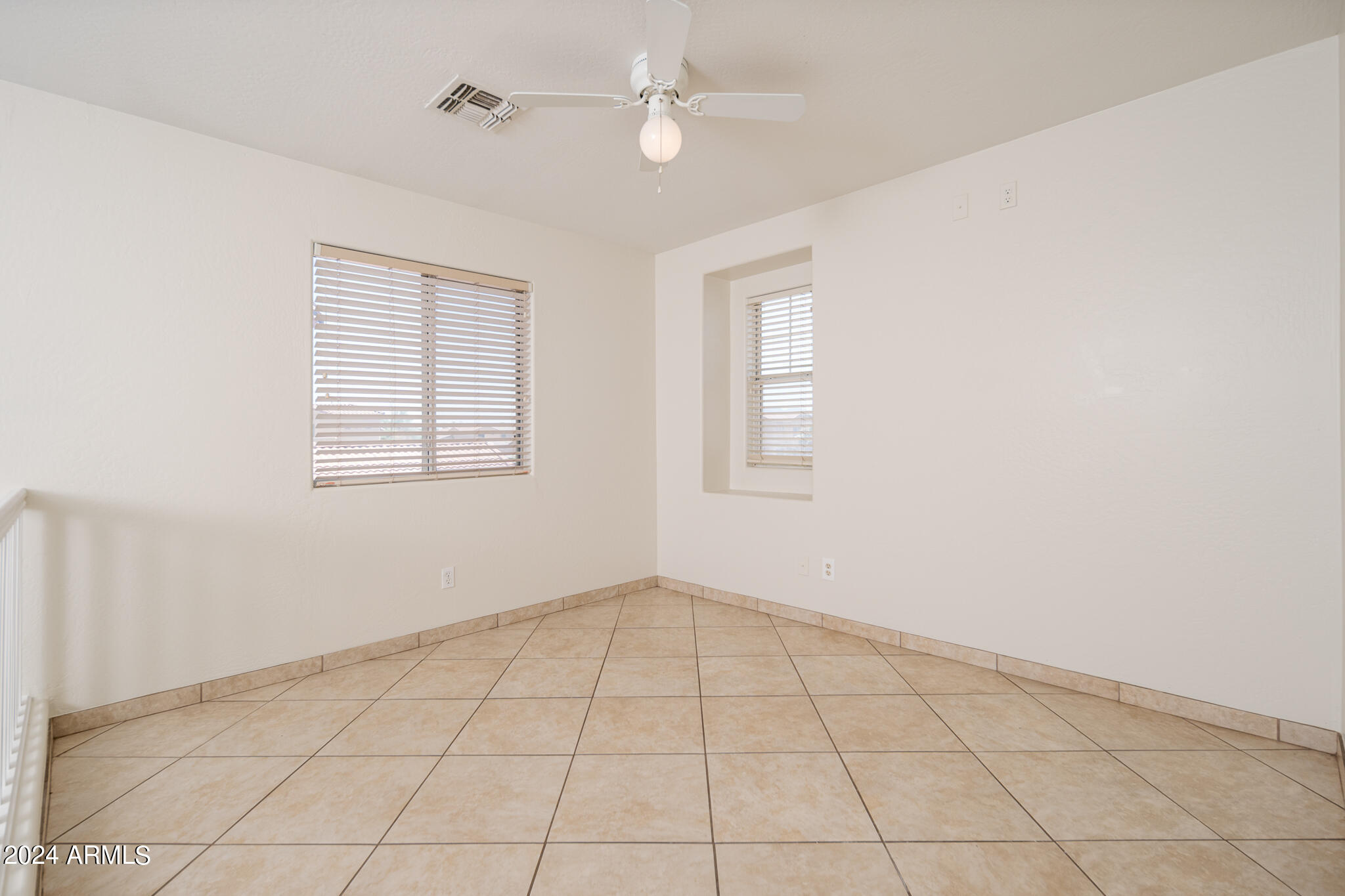 7208 West Crown King Road Phoenix, AZ 85043 - Photo 13 of 42 an empty room with windows and fan