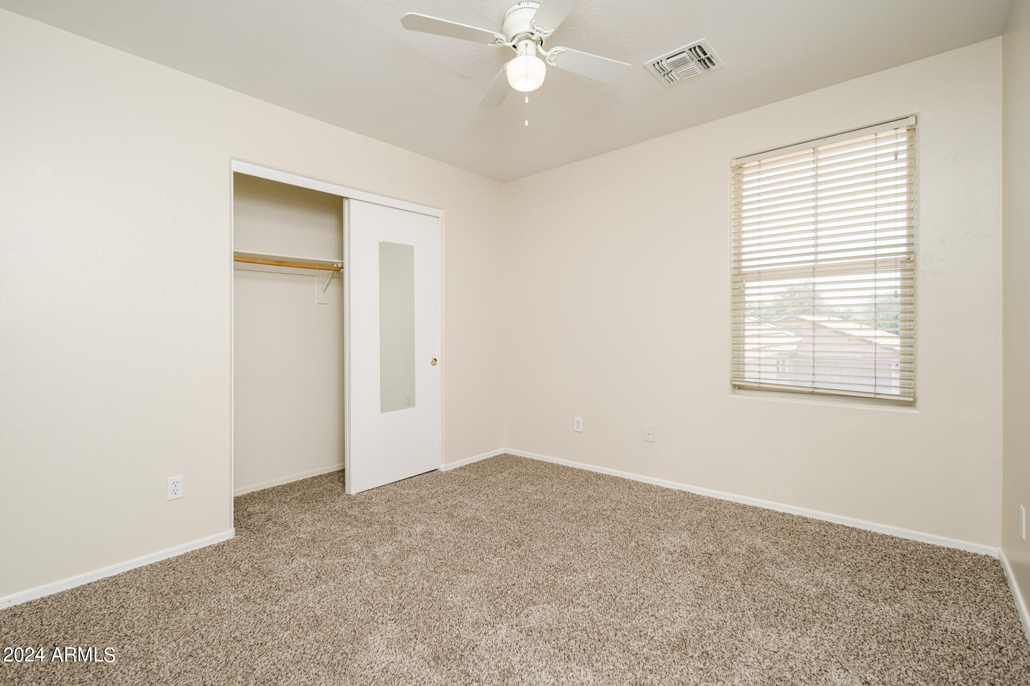 7208 West Crown King Road Phoenix, AZ 85043 - Photo 18 of 42 an empty room with a window and a fan