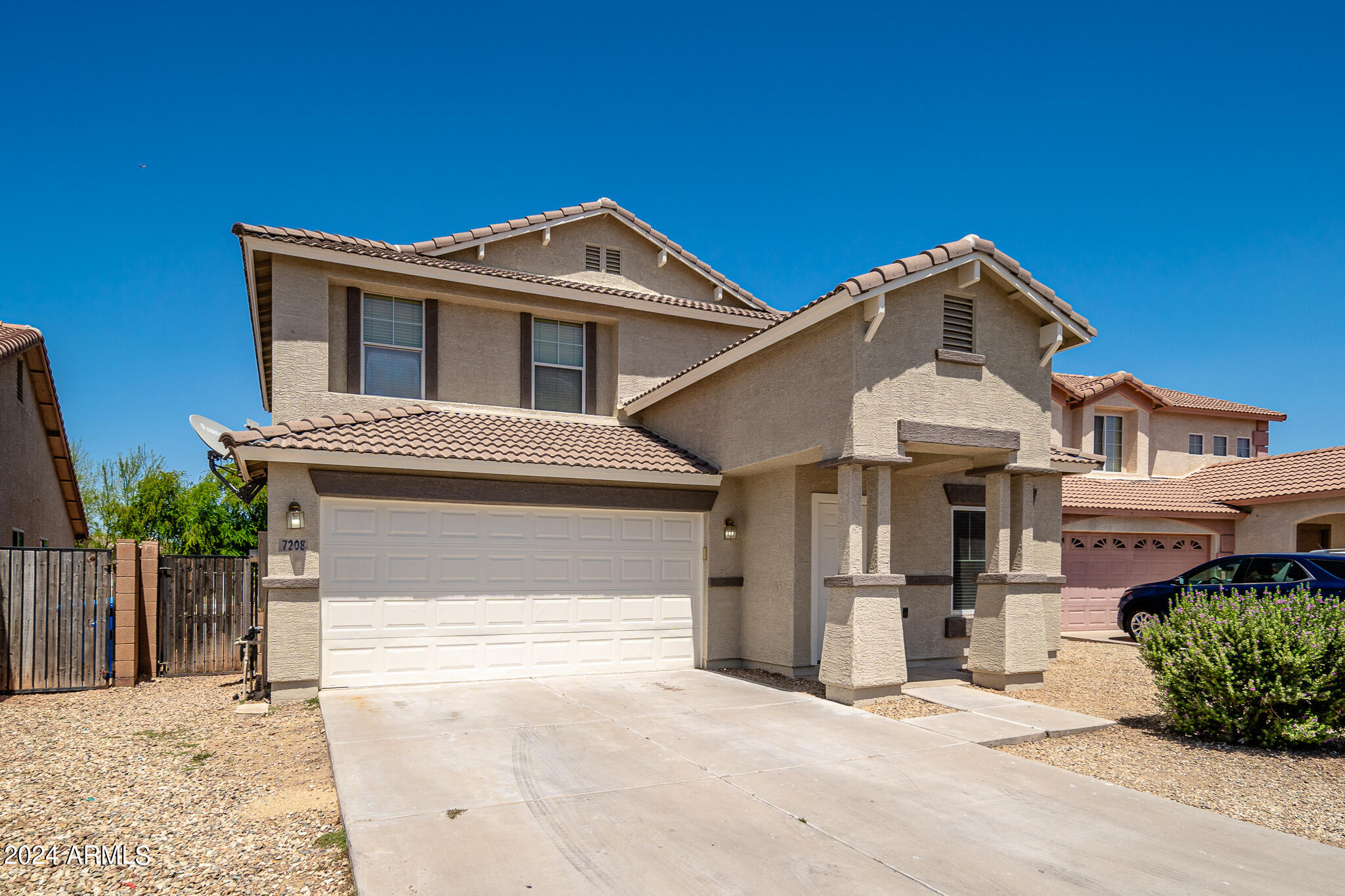 7208 West Crown King Road Phoenix, AZ 85043 - Photo 2 of 42 a front view of a house with a garden