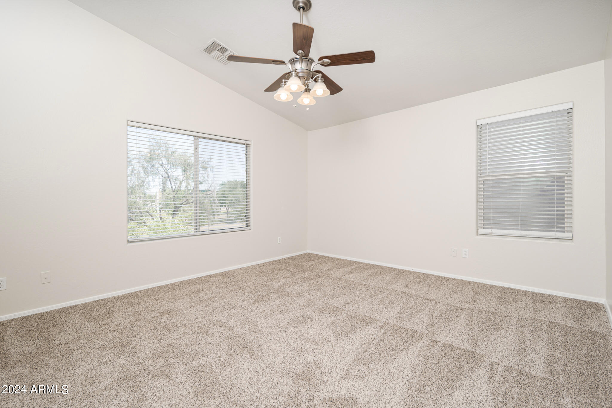 7208 West Crown King Road Phoenix, AZ 85043 - Photo 21 of 42 an empty room with a window and a ceiling fan