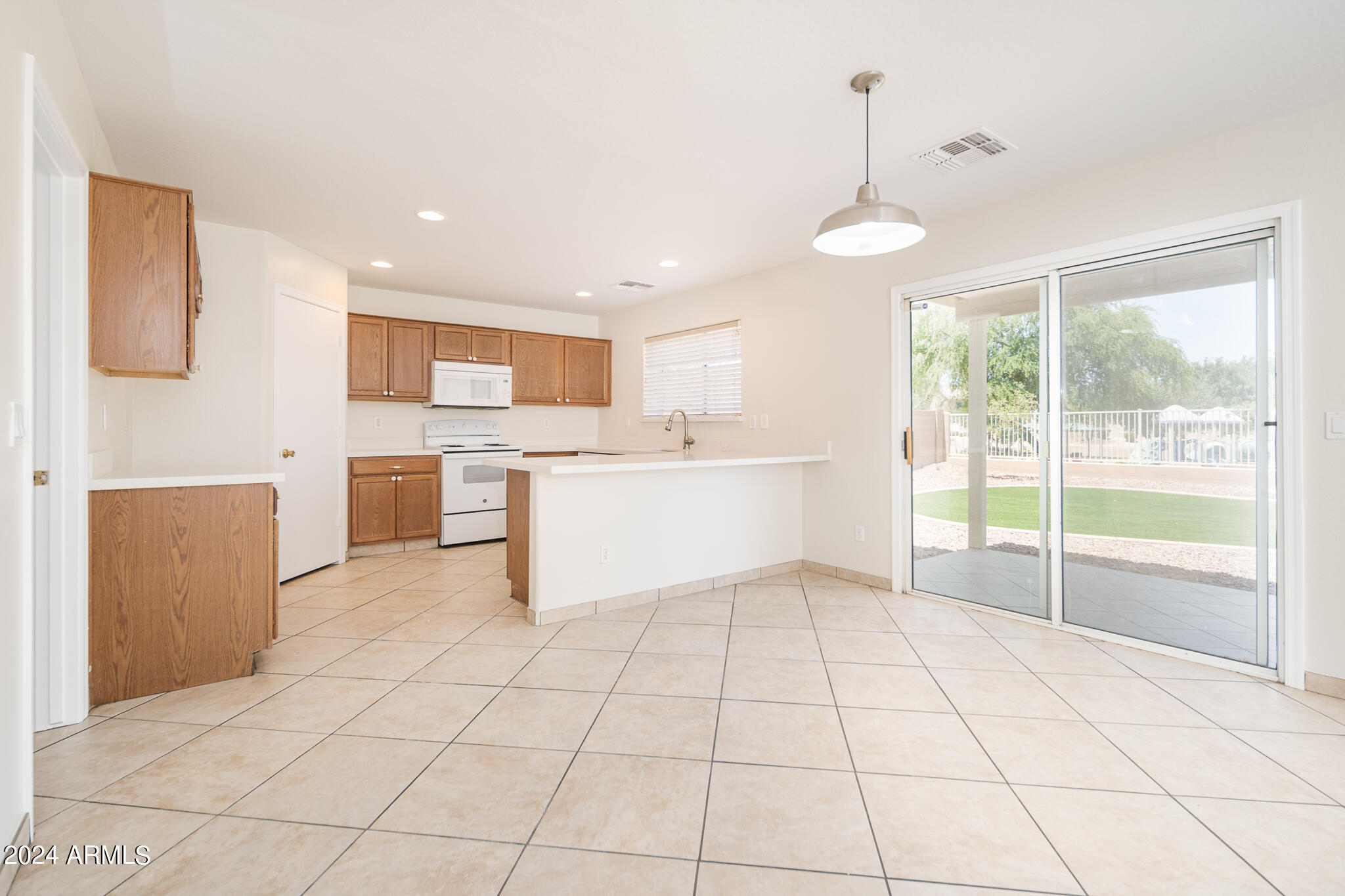 7208 West Crown King Road Phoenix, AZ 85043 - Photo 8 of 42 a view of a kitchen with furniture wooden floor and window