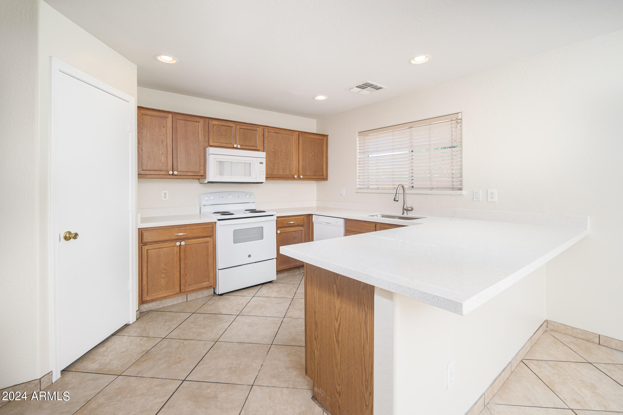 7208 West Crown King Road Phoenix, AZ 85043 - Photo 9 of 42 a kitchen with a sink a stove cabinets and a refrigerator
