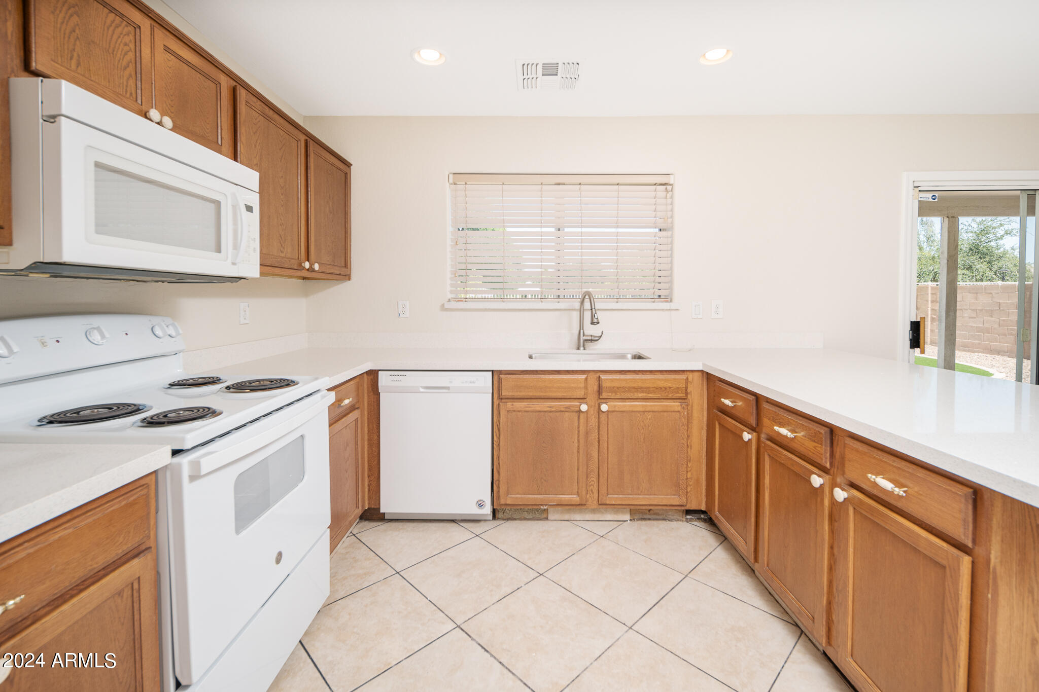 7208 West Crown King Road Phoenix, AZ 85043 - Photo 10 of 42 a kitchen with a sink stove and cabinets