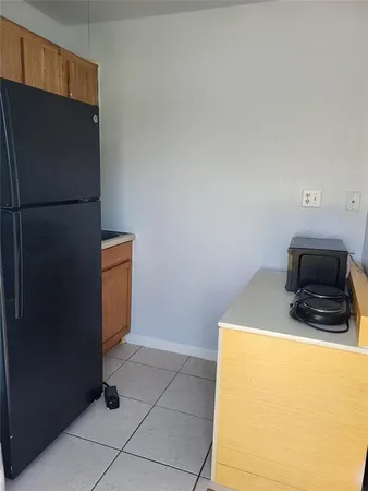 a kitchen with a refrigerator and a stove
