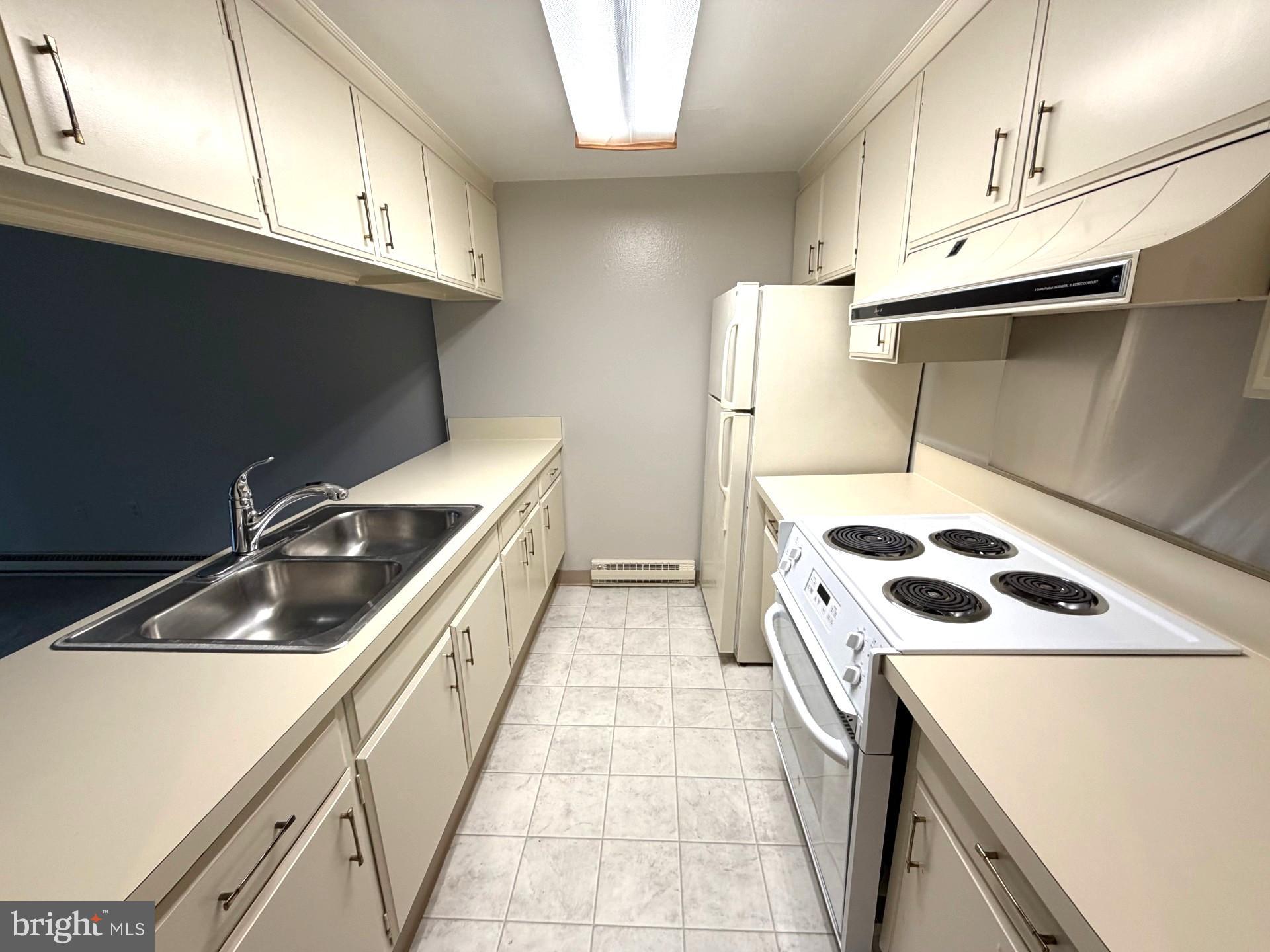 3320 Chiswick Court, Unit 611D Silver Spring, MD 20906 - Photo 14 of 38 a kitchen that has a sink and a stove