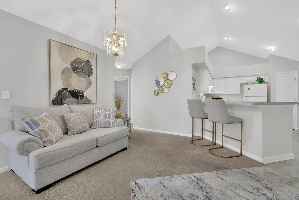 3057 Orchard Ridge Circle Duluth, GA 30096 - Photo 11 of 37 a living room with furniture and a chandelier