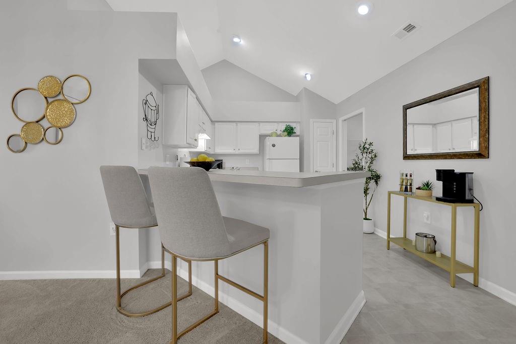 3057 Orchard Ridge Circle Duluth, GA 30096 - Photo 12 of 37 a kitchen with cabinets and chairs