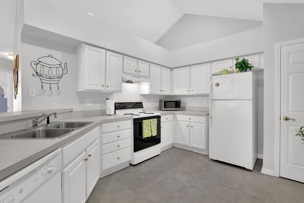 3057 Orchard Ridge Circle Duluth, GA 30096 - Photo 14 of 37 a kitchen with white cabinets and white appliances
