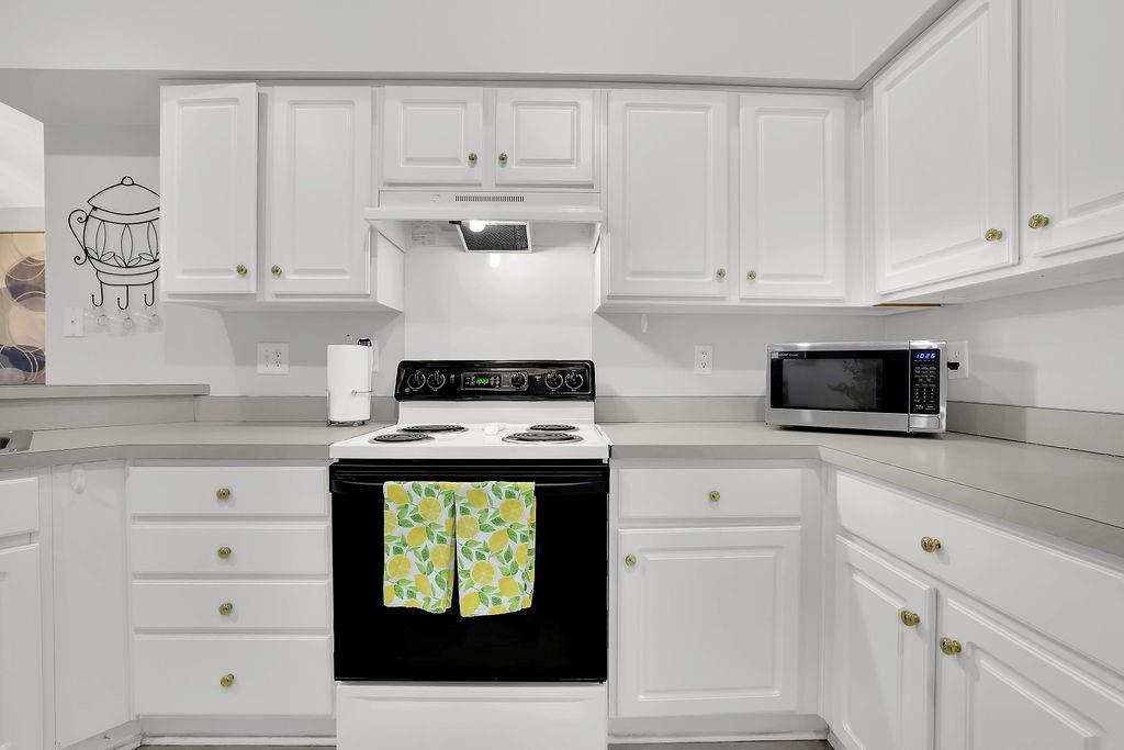 3057 Orchard Ridge Circle Duluth, GA 30096 - Photo 15 of 37 a kitchen with white cabinets and appliances