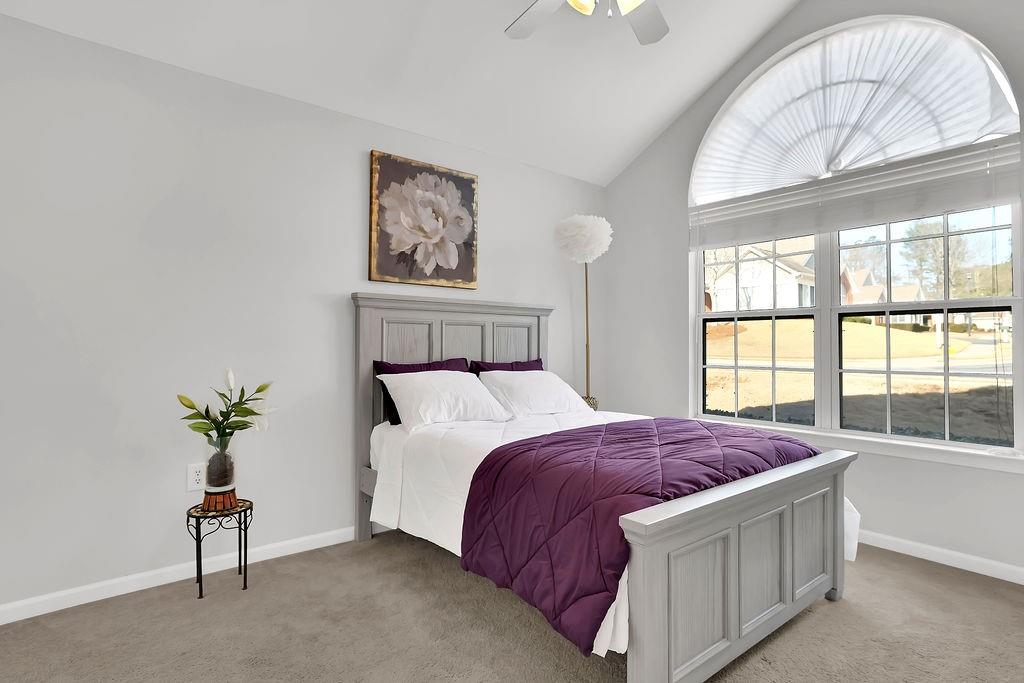 3057 Orchard Ridge Circle Duluth, GA 30096 - Photo 19 of 37 a bedroom with a bed and a large window
