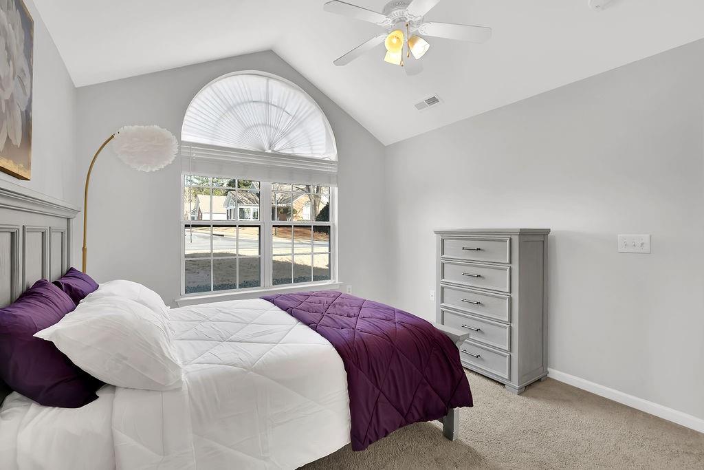 3057 Orchard Ridge Circle Duluth, GA 30096 - Photo 20 of 37 a bedroom with a bed a dresser and a window