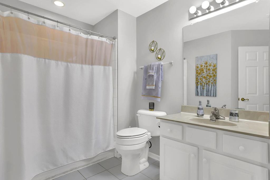 3057 Orchard Ridge Circle Duluth, GA 30096 - Photo 21 of 37 a bathroom with a sink a toilet and a mirror