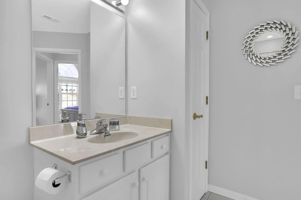 3057 Orchard Ridge Circle Duluth, GA 30096 - Photo 22 of 37 a bathroom with a sink vanity and a mirror