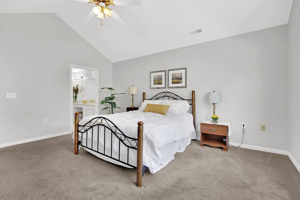 3057 Orchard Ridge Circle Duluth, GA 30096 - Photo 28 of 37 a bedroom with a bed and a chandelier