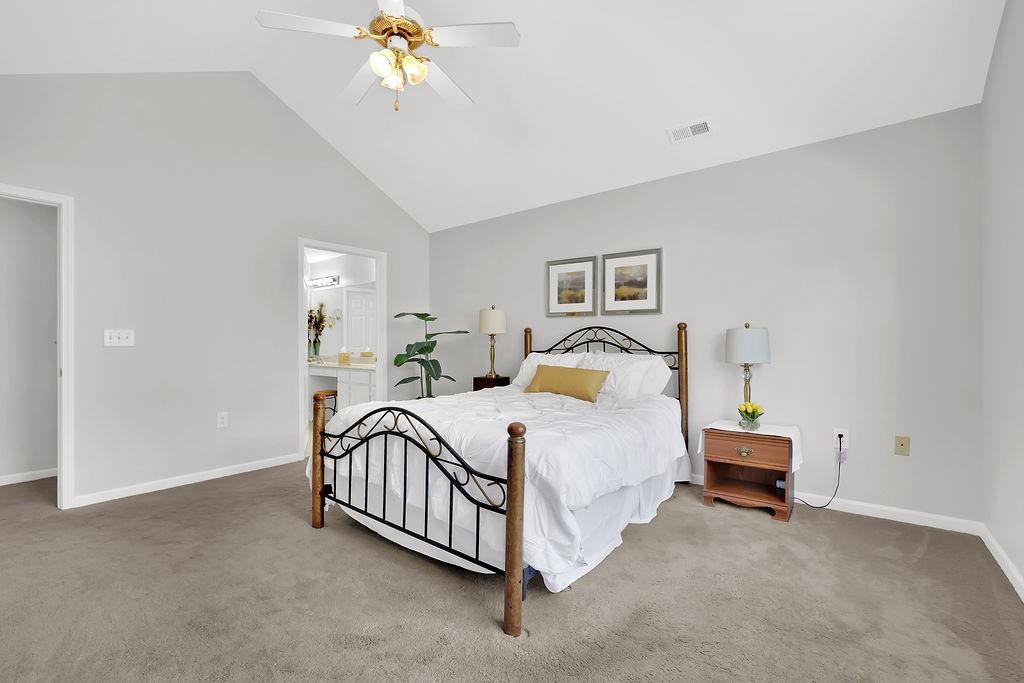 3057 Orchard Ridge Circle Duluth, GA 30096 - Photo 29 of 37 a bedroom with a bed and a chandelier