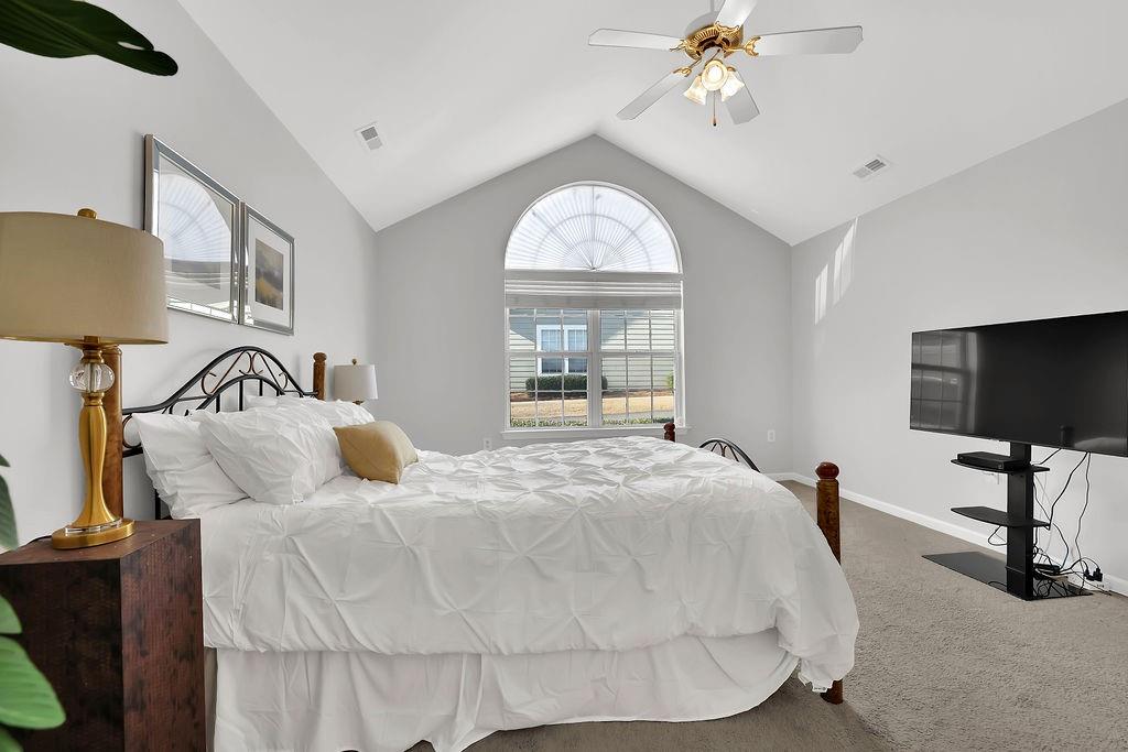 3057 Orchard Ridge Circle Duluth, GA 30096 - Photo 30 of 37 a bedroom with a bed and a chandelier