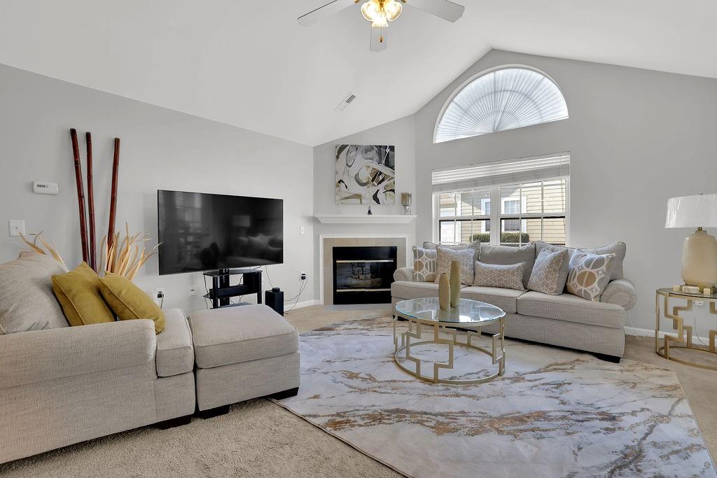 3057 Orchard Ridge Circle Duluth, GA 30096 - Photo 4 of 37 a living room with furniture a fireplace and a flat screen tv