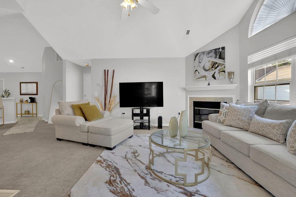 3057 Orchard Ridge Circle Duluth, GA 30096 - Photo 5 of 37 a living room with furniture a flat screen tv and a fireplace