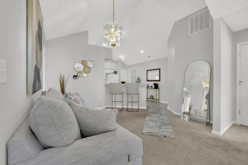 3057 Orchard Ridge Circle Duluth, GA 30096 - Photo 10 of 37 a living room with furniture and a chandelier