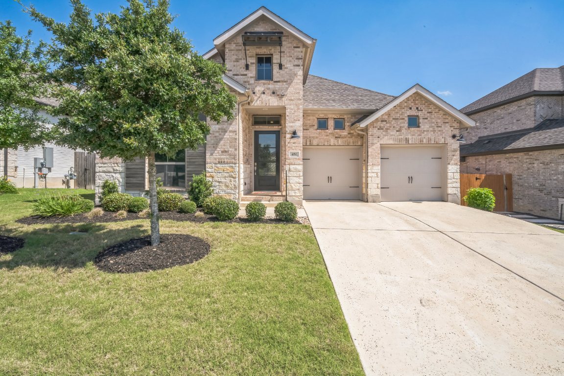 a front view of a house with garden