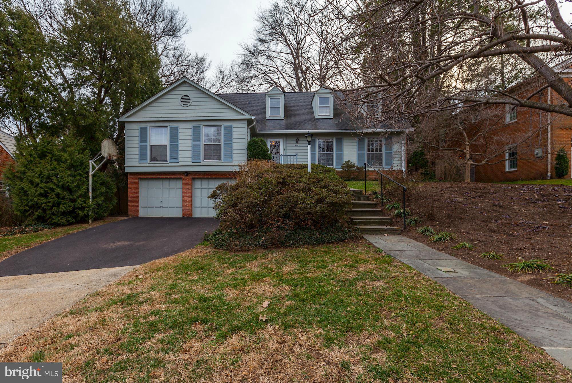 5502 Pollard Road Bethesda, MD 20816 - Photo 2 of 30 a front view of a house with a yard and garage